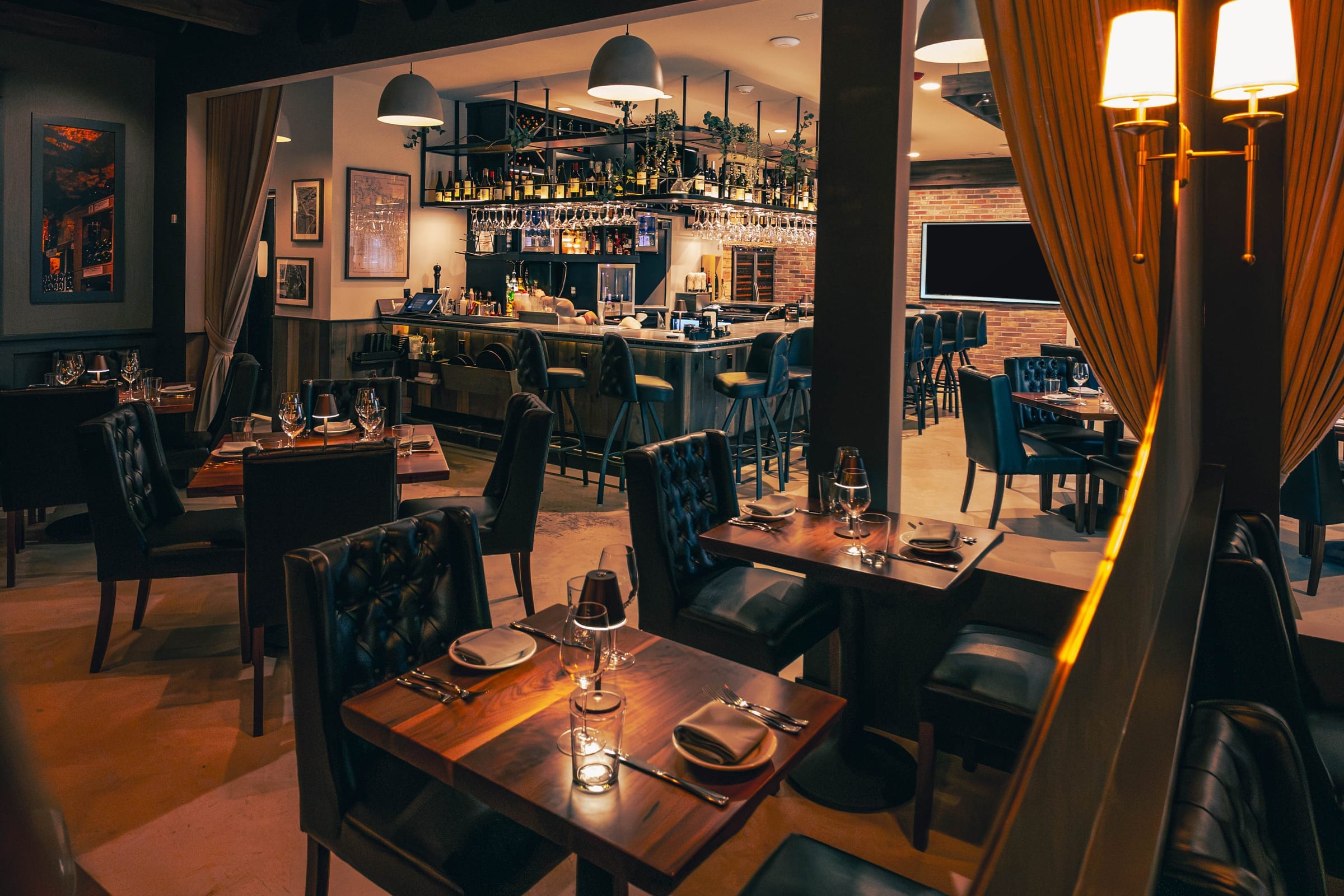 The dining room and bar at Enology Wine Bar and Bistro, lit low for the evening
