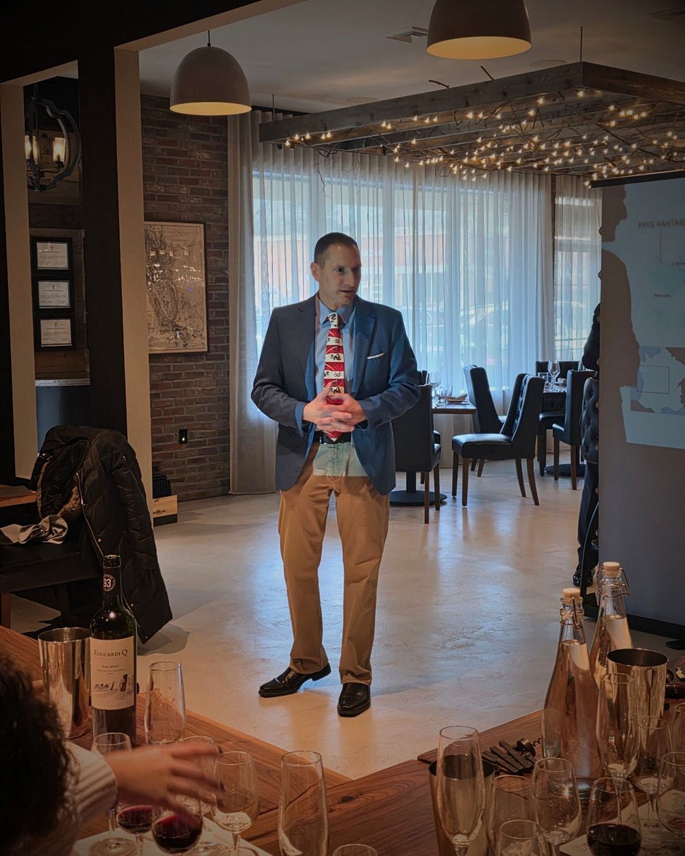 A host leading a wine class at Enology Wine Bar and Bistro