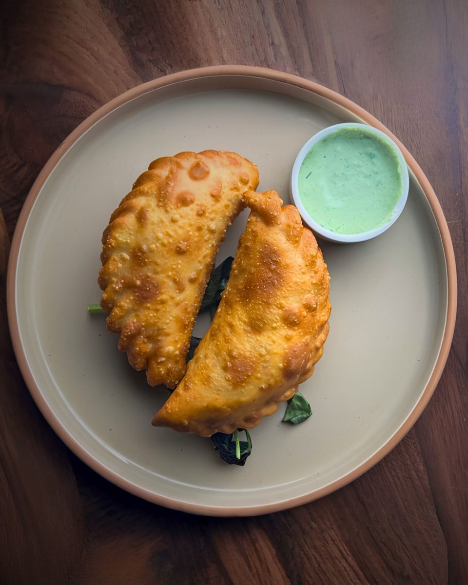 Golden empanadas with a bright green verde dipping sauce