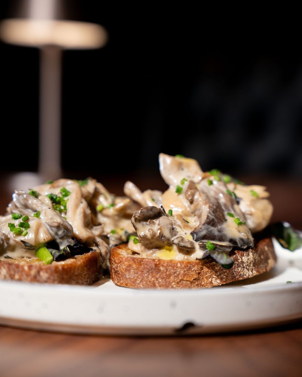 Wild mushrooms in a cream sauce over grilled sourdough, finished with chives