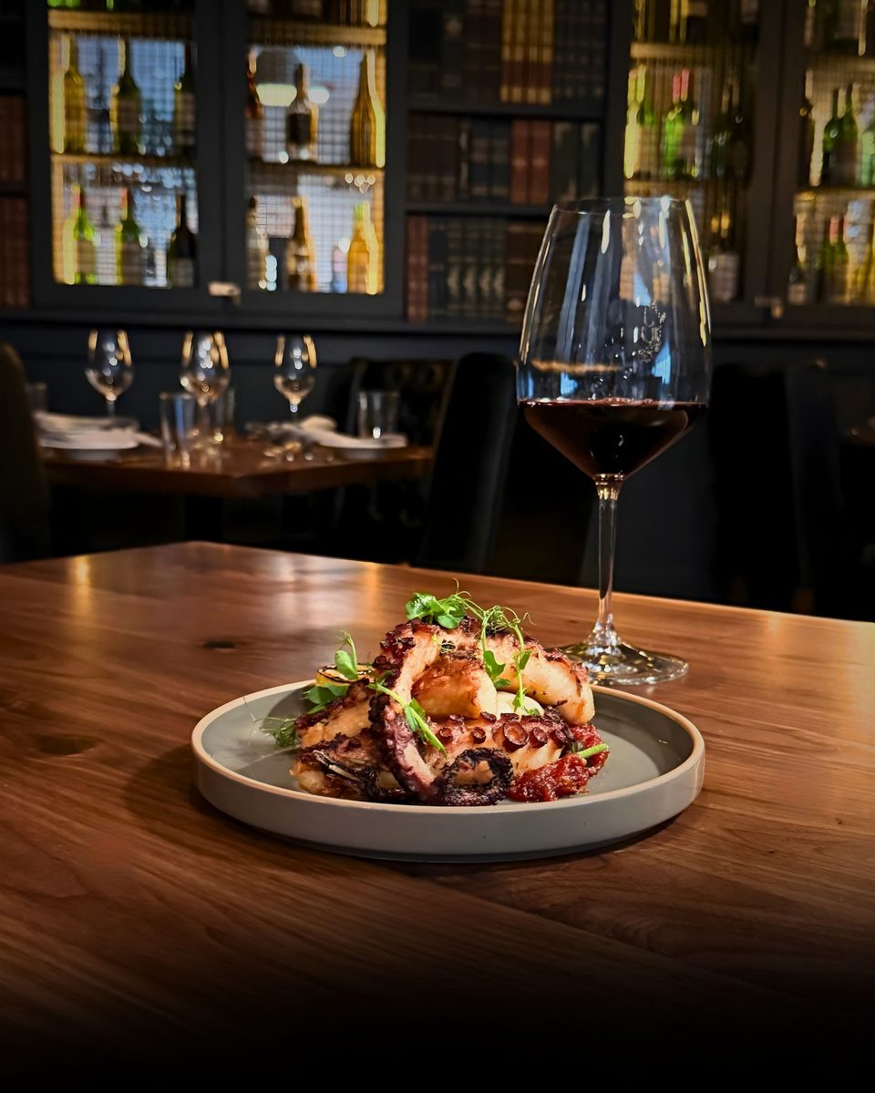 Charred octopus with a glass of red wine