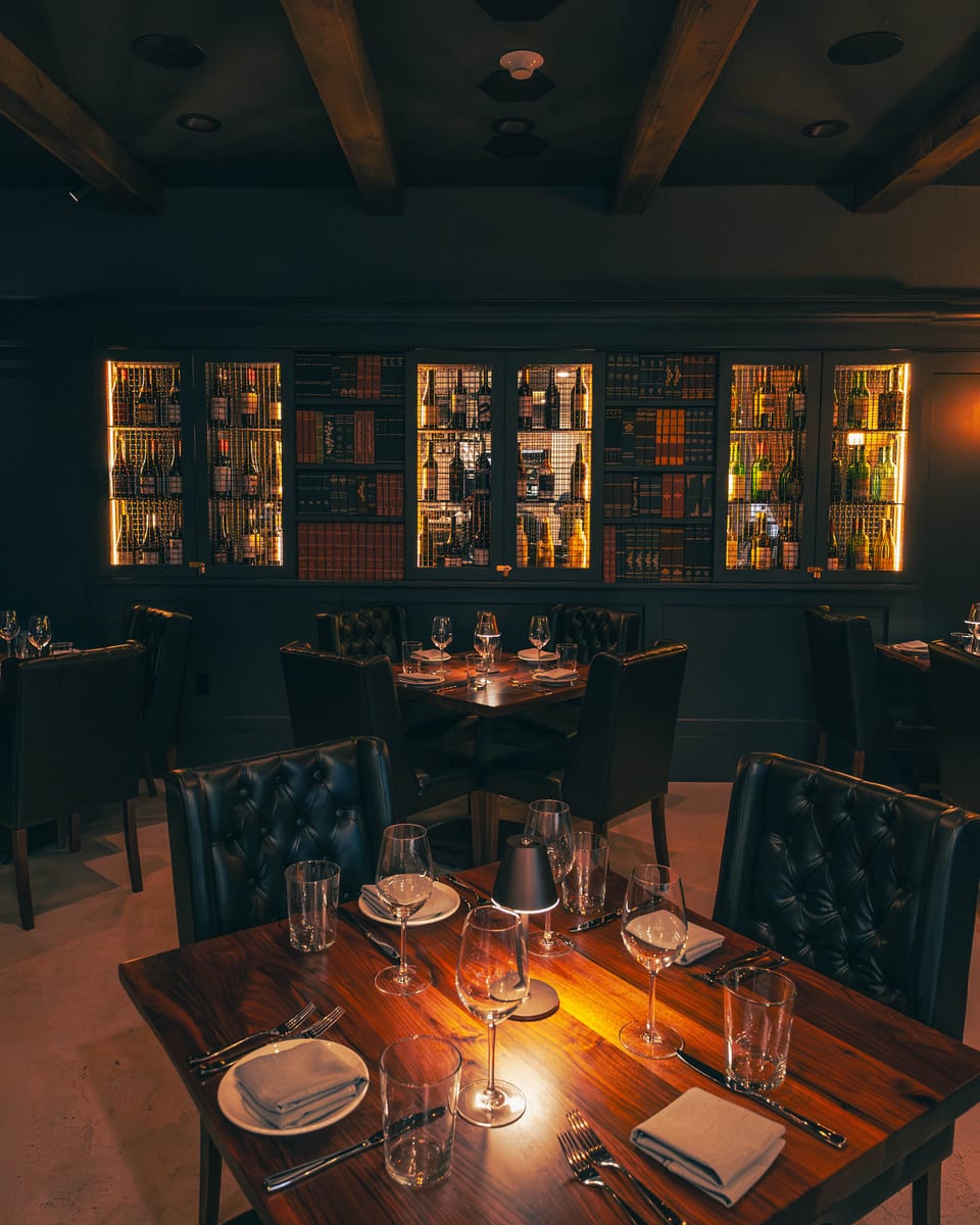 The warmly lit dining room at Enology Wine Bar & Bistro in Saint James, New York