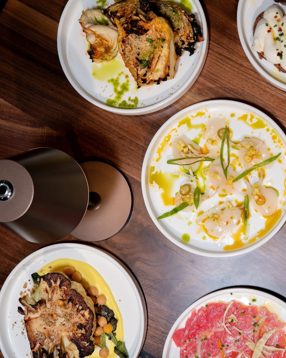 An overhead view of a table set with small plates at Enology Wine Bar & Bistro