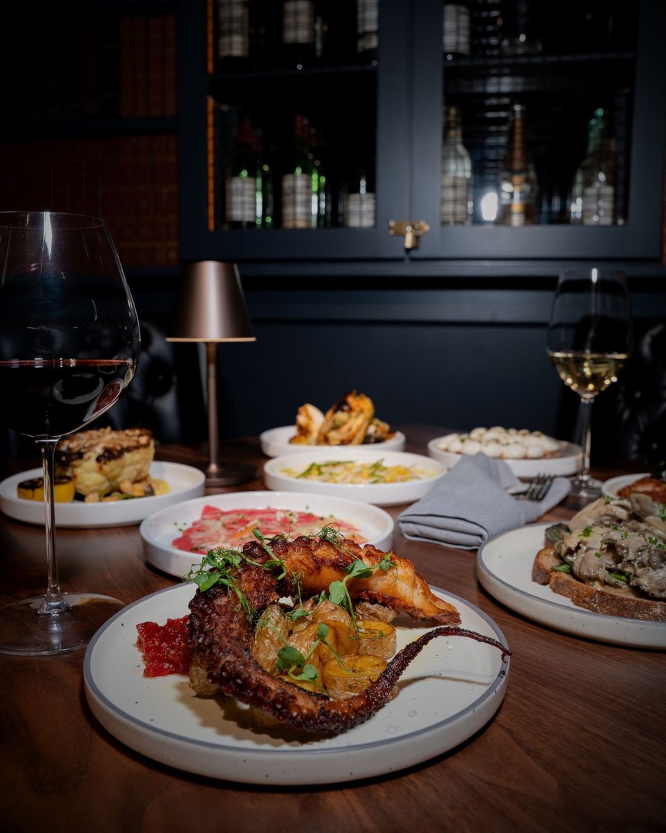 A celebratory spread of small plates and wine at Enology Wine Bar & Bistro