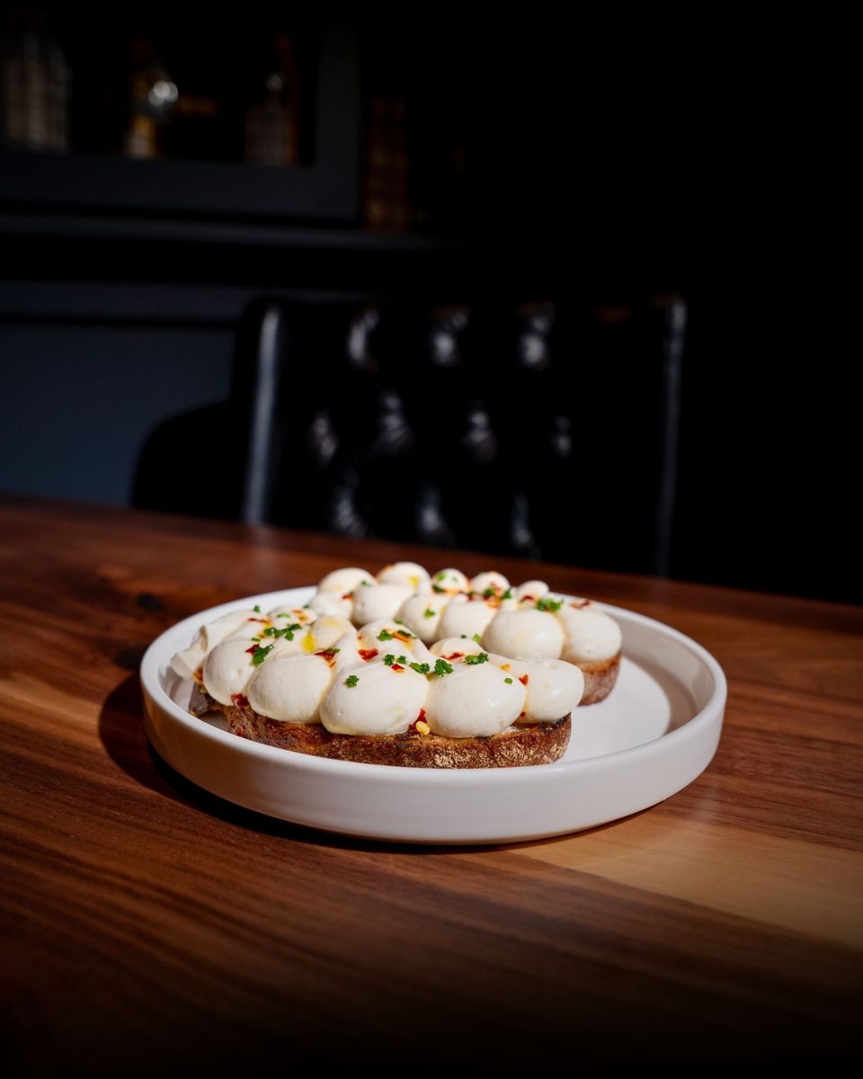 Whipped ricotta on grilled bread, plated simply